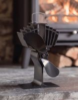 The 25cm Black "Air Max" Eco Wood Stove Fan on a Stone Hearth in Front of a Lit Log Burner Stove - Digital Illustration The 25cm Black "Air Max" Eco Wood Stove Fan on a Stone Hearth in Front of a Lit Log Burner Stove - Digital Illustration