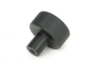 The 25mm "Vesper" Knurled Edge Cabinet Knob in Matt Black on a White Background Shown from Behind