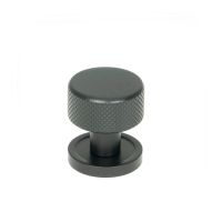 The 25mm Knurled Cabinet Knob on a Plain Rose in Matt Black Shown Upright on a White Background The 25mm Knurled Cabinet Knob on a Plain Rose in Matt Black Shown Upright on a White Background