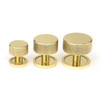 The 25mm Knurled Cabinet Knob on a Plain Rose in Polished Brass Alongside Different Sizes The 25mm Knurled Cabinet Knob on a Plain Rose in Polished Brass Alongside Different Sizes