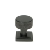 The 25mm Knurled Cabinet Knob on a Square Rose in Aged Bronze Shown Upright on a White Background The 25mm Knurled Cabinet Knob on a Square Rose in Aged Bronze Shown Upright on a White Background