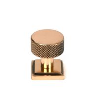 The 25mm Knurled Cabinet Knob on a Square Rose in Polished Bronze Shown Upright on a White Background 
