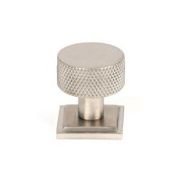 The 25mm Knurled Cabinet Knob on Square Rose in Satin Stainless Steel Shown Upright on a White Background The 25mm Knurled Cabinet Knob on Square Rose in Satin Stainless Steel Shown Upright on a White Background