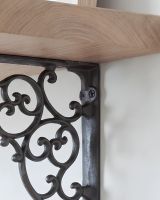 The 27.5cm x 20.5cm Cast Iron Ornate Scroll Shelf Bracket Showing a close up of the Integrated Screw Holes The 27.5cm x 20.5cm Cast Iron Ornate Scroll Shelf Bracket Showing a close up of the Integrated Screw Holes