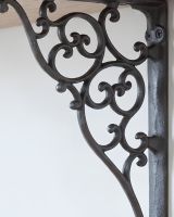 The 27.5cm x 20.5cm Cast Iron Ornate Scroll Shelf Bracket Showing a Close up of the Scrollwork The 27.5cm x 20.5cm Cast Iron Ornate Scroll Shelf Bracket Showing a Close up of the Scrollwork