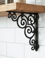 The 27 x 25cm "Paradise House" Cast Iron Scroll Shelf Bracket Mounted on a White Tiled Kitchen Wall in a Modern Home - Digital Illustration The 27 x 25cm "Paradise House" Cast Iron Scroll Shelf Bracket Mounted on a White Tiled Kitchen Wall in a Modern Home - Digital Illustration