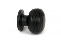 The 30mm "Garrison" Ribbed Beehive Knob in Matt Black on a White Background Displayed from the Side