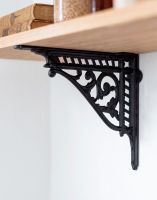 The 31 x 26cm Heritage Style Black Shelf Bracket Used as a DIY Shelf on a White Interior Wall - Digital Illustration