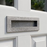The 32cm Pewter Cast Traditional Letter Plate Mounted on a Bright White Timber Door The 32cm Pewter Cast Traditional Letter Plate Mounted on a Bright White Timber Door
