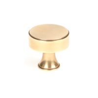 The 32mm "Atelier" Circular Cabinet Knob in Aged Brass on a White Background Stood Upright 