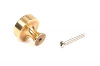 The 32mm "Atelier" Circular Cabinet Knob in Aged Brass on a White Background with a Screw