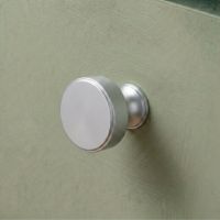 The 32mm "Atelier" Circular Cabinet Knob in Satin Chrome Designed for Kitchen Cupboards Mounted on a Mint Green Drawer - Digital Illustration