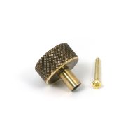 The 32mm Knurled Cabinet Knob (No Rose) in Aged Brass Shown with Fitting Bolt on a White Background The 32mm Knurled Cabinet Knob (No Rose) in Aged Brass Shown with Fitting Bolt on a White Background