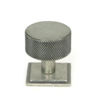 The 32mm Knurled Cabinet Knob on a Square Rose in Pewter Shown Upright on a White Background The 32mm Knurled Cabinet Knob on a Square Rose in Pewter Shown Upright on a White Background