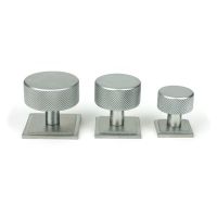 The 32mm Knurled Cabinet Knob on a Square Rose in Satin Chrome Next to Other Available Sizes on a White Background The 32mm Knurled Cabinet Knob on a Square Rose in Satin Chrome Next to Other Available Sizes on a White Background