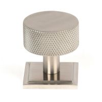 The 32mm Knurled Cabinet Knob on a Square Rose in Satin Stainless Steel Shown Upright on a White Background The 32mm Knurled Cabinet Knob on a Square Rose in Satin Stainless Steel Shown Upright on a White Background