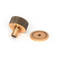 The 32mm Knurled Cabinet Knob on Plain Rose in Polished Bronze Shown from Behind on a White Background The 32mm Knurled Cabinet Knob on Plain Rose in Polished Bronze Shown from Behind on a White Background
