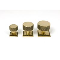 The 32mm Knurled Cabinet Knob on Square Rose in Aged Brass Alongside Different Sizes on a White Background The 32mm Knurled Cabinet Knob on Square Rose in Aged Brass Alongside Different Sizes on a White Background