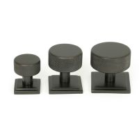 The 32mm Knurled Cabinet Knob on Square Rose in Aged Bronze Alongside Different Sizes The 32mm Knurled Cabinet Knob on Square Rose in Aged Bronze Alongside Different Sizes