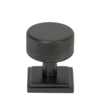 The 32mm Knurled Cabinet Knob on Square Rose in Aged Bronze Shown Upright on a White Background The 32mm Knurled Cabinet Knob on Square Rose in Aged Bronze Shown Upright on a White Background