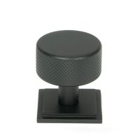 The 32mm Knurled Cabinet Knob on Square Rose in Matt Black Shown Upright on a White Background The 32mm Knurled Cabinet Knob on Square Rose in Matt Black Shown Upright on a White Background