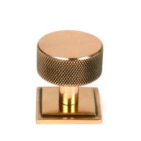 The 32mm Knurled Cabinet Knob on Square Rose in Polished Bronze Shown Upright on a White Background The 32mm Knurled Cabinet Knob on Square Rose in Polished Bronze Shown Upright on a White Background