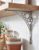 The 33 x 33cm Large Bright Chrome "Iron Bridge" Shelf Bracket Mounted on a White Tiled Kitchen Wall in a Modern Home - Digital Illustration 