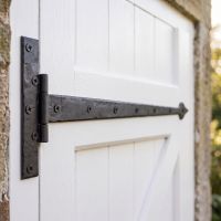 The 36" External Beeswax Hook & Band Tee Hinge Fitted onto a White Garage Door - Digital Illustration