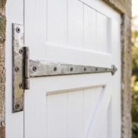 The 36" Pewter Hook & Band Tee Hinge on a White Wooden External Garage Door - Digital Illustration