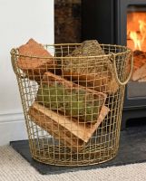 The 36cm Brass Plated Wire Log Basket in a Modern Home next to a Black Log Burner Stove - Digital Illustration 