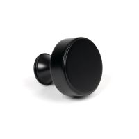 The 38mm "Atelier" Circular Cabinet Knob in Matt Black on a White Background Shown Side On 