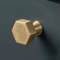 The 38mm "Vanguard" Hexagonal Cabinet Knob in Aged Brass Fitted on a Blue Cupboard Perfect for Kitchen Drawers - Digital Illustration The 38mm "Vanguard" Hexagonal Cabinet Knob in Aged Brass Fitted on a Blue Cupboard Perfect for Kitchen Drawers - Digital Illustration