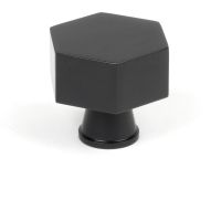 The 38mm "Vanguard" Hexagonal Cabinet Knob in Matt Black on a White Background Shown Stood Upright 