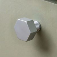 The 38mm "Vanguard" Hexagonal Cabinet Knob in Satin Chrome Displayed on a Sage Green Kitchen Cabinet Drawer - Digital Illustration