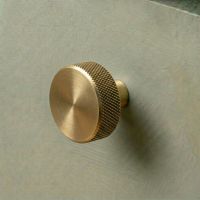 The 38mm "Vesper" Knurled Edge Cabinet Knob in Aged Brass Designed for Kitchen Cupboards Displayed on a Green Drawer - Digital Illustration The 38mm "Vesper" Knurled Edge Cabinet Knob in Aged Brass Designed for Kitchen Cupboards Displayed on a Green Drawer - Digital Illustration