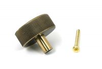The 38mm "Vesper" Knurled Edge Cabinet Knob in Aged Brass on a White Background Shown from Behind with the Screw