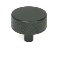 The 38mm "Vesper" Knurled Edge Cabinet Knob in Matt Black on a White Background Shown Stood Upright 