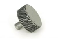 The 38mm "Vesper" Knurled Edge Cabinet Knob in Pewter Mounted on a White Background Shown frm the Side