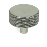 The 38mm "Vesper" Knurled Edge Cabinet Knob in Pewter Mounted on a White Background Stood Upright 