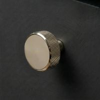 The 38mm "Vesper" Knurled Edge Cabinet Knob in Polished Nickel Designed for Kitchen Cupboards Displayed on a Contemporary Wooden Drawer - Digital Illustration The 38mm "Vesper" Knurled Edge Cabinet Knob in Polished Nickel Designed for Kitchen Cupboards Displayed on a Contemporary Wooden Drawer - Digital Illustration