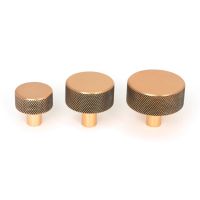 The 38mm Knurled Cabinet Knob (No Rose) in Polished Bronze Next to Other Available Sizes on a White Background The 38mm Knurled Cabinet Knob (No Rose) in Polished Bronze Next to Other Available Sizes on a White Background