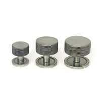 The 38mm Knurled Cabinet Knob on a Plain Rose in Pewter Next to Other Available Sizes on a White Background The 38mm Knurled Cabinet Knob on a Plain Rose in Pewter Next to Other Available Sizes on a White Background