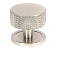 The 38mm Knurled Cabinet Knob on a Plain Rose in Satin Stainless Steel Shown Upright on a White Background The 38mm Knurled Cabinet Knob on a Plain Rose in Satin Stainless Steel Shown Upright on a White Background