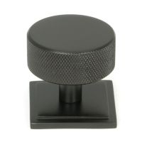 The 38mm Knurled Cabinet Knob on a Square Rose in Aged Bronze Shown Upright on a White Background