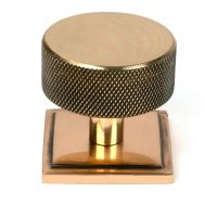 The 38mm Knurled Cabinet Knob on a Square Rose in Polished Bronze Shown Upright on a White Background