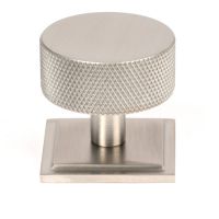 The 38mm Knurled Cabinet Knob on a Square Rose in Satin Stainless Steel Shown Upright on a White Background The 38mm Knurled Cabinet Knob on a Square Rose in Satin Stainless Steel Shown Upright on a White Background