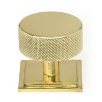 The 38mm Knurled Cabinet Knob on Square Rose in Polished Brass Shown Upright on a White Background The 38mm Knurled Cabinet Knob on Square Rose in Polished Brass Shown Upright on a White Background