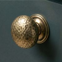 The 38mm Polished Copper Hammered Mushroom Cabinet Knob on a Contemporary Blue Kitchen Cupboard - Digital Illustration
