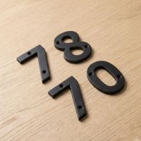 The 3 Inch Black Iron House Numerals Laid out on a Table Top - Digital Illustration