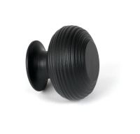 The 40mm "Garrison" Ribbed Beehive Knob in Matt Black on a White Background Shown side on